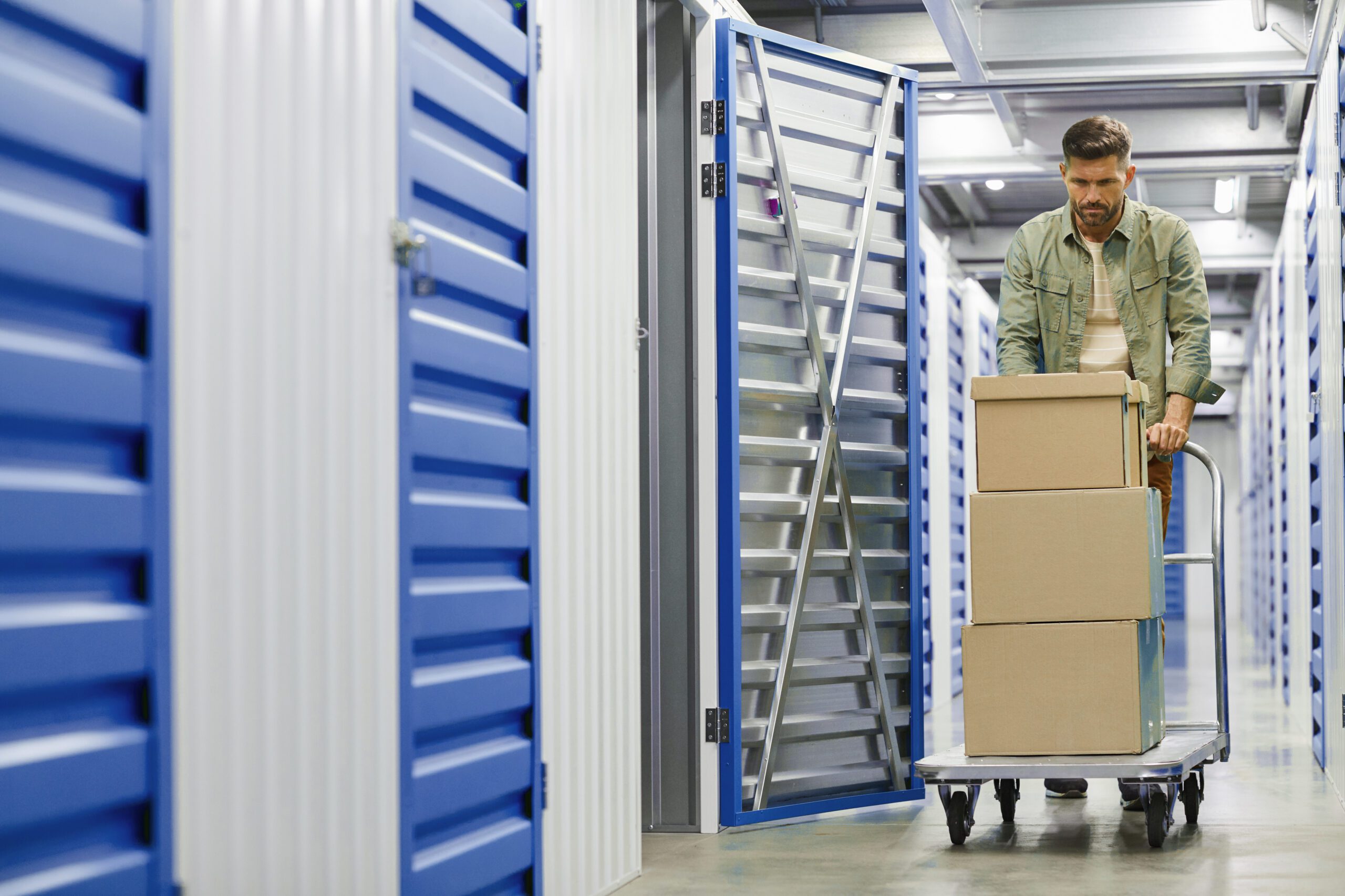 Man Moving Boxes in Self Storage Unit